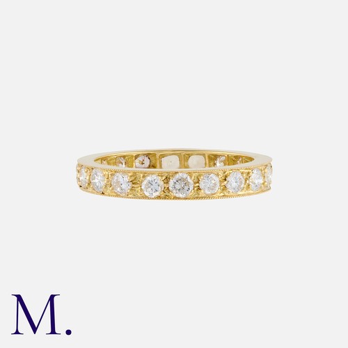 115 - A Diamond Eternity Ring in yellow gold, set throughout with round cut diamonds totalling approximate... 