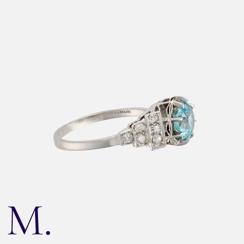 130 - A Zircon And Diamond Ring in platinum, set with a round cut zircon of approximately 1.80ct, accented... 
