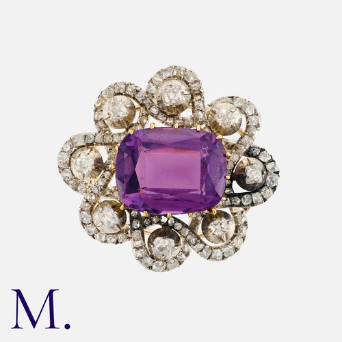 83 - An Antique Amethyst And Diamond Brooch in yellow gold and silver, set with a central cushion shaped ... 