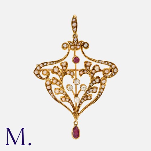 68 - A Ruby, Pearl And Diamond Brooch Pendant in 15k yellow gold, of scrolling foliate design, set throug... 