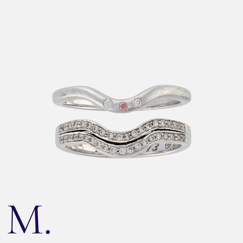 256 - A Pair of Diamond 'Enhancer' Rings in 9K white gold.  Ring one set with two rows of round cut diamon... 