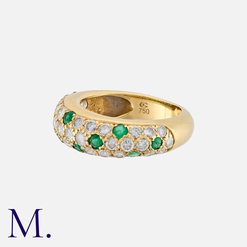 173 - An Emerald And Diamond Ring in 18k yellow gold. Set with round cut diamonds totalling approximately ... 