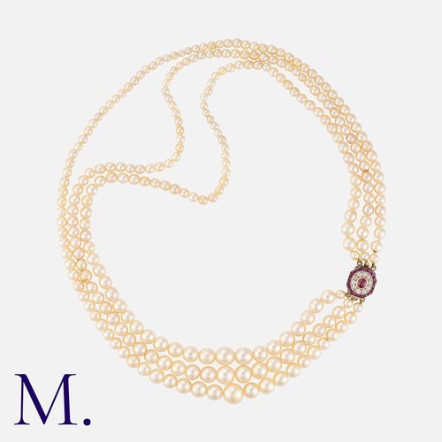 143 - A Pearl Necklace in yellow and white gold, comprising three strings of drilled pearls ranging from a... 