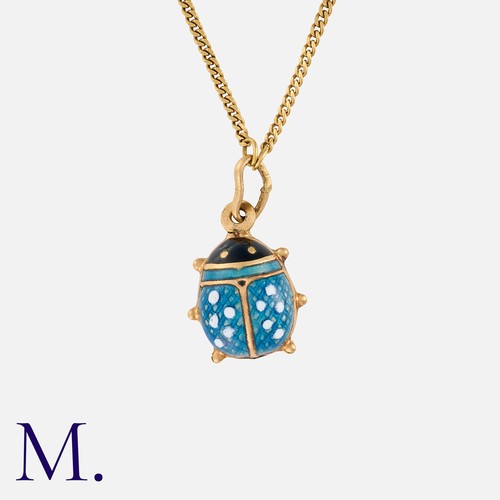 141 - An Enamel Ladybird Pendant and Chain in 18K yellow gold, with blue, white and black enamel pendant s... 