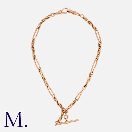 180 - An Antique Fancy Link Albert Chain in 9K rose gold with T-Bar pendant and lobster clip fastenings. M... 