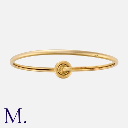 125 - CARTIER. A Sapphire Bangle in 18K yellow gold, set with a cabochon sapphire. Signed Cartier, serial ... 
