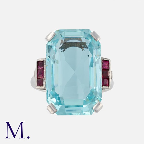 137 - An Aquamarine and Ruby Ring in white gold, comprising a principal; octagonal step cut aquamarine of ... 
