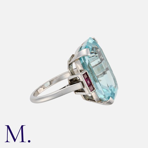 137 - An Aquamarine and Ruby Ring in white gold, comprising a principal; octagonal step cut aquamarine of ... 