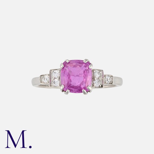 161 - An Art Deco Pink Sapphire and Diamond Ring in platinum, comprising a cushion cut sapphire of approxi... 