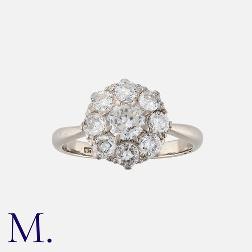 127 - A Diamond Cluster Ring in 18 carat white gold, comprising a central transitional cut diamond of appr... 