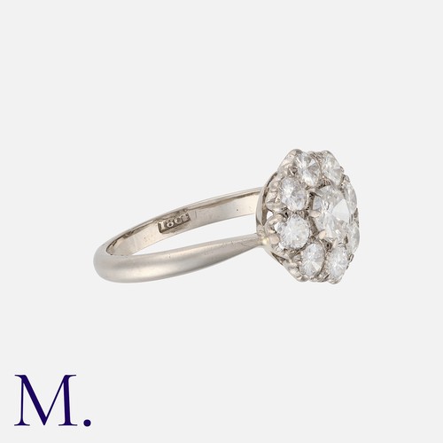 127 - A Diamond Cluster Ring in 18 carat white gold, comprising a central transitional cut diamond of appr... 