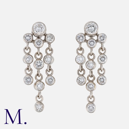 128 - A Pair of Diamond Drop Earrings in 18K white gold, each earring set with a principal round brilliant... 