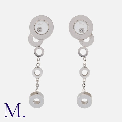 163 - CHOPARD. A Pair of Happy Diamond Drop Earrings in 18K white gold, with glazed circular design with f... 