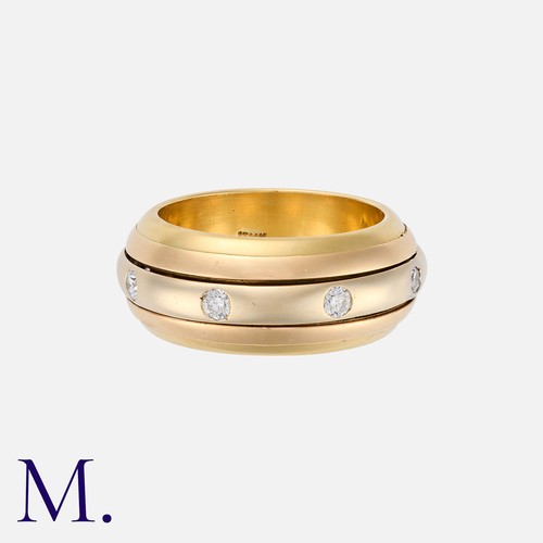 170 - A Diamond Rolling Band in 18K yellow and white gold, set with eight round cut diamonds around a roll... 