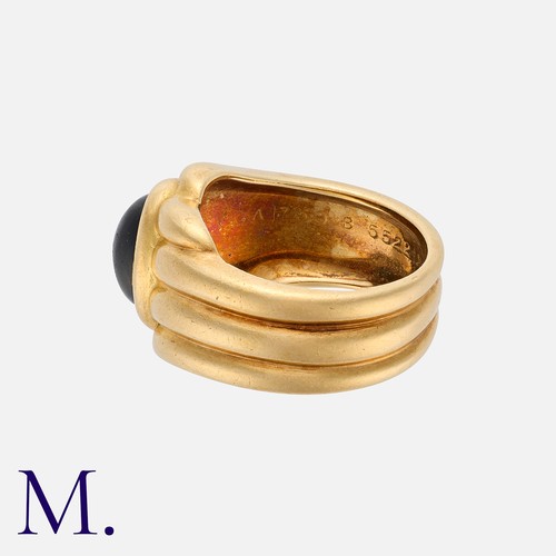 131 - VAN CLEEF & ARPELS. An Onyx Ring in 18K yellow gold, set with a cabochon onyx to the centre with flu... 