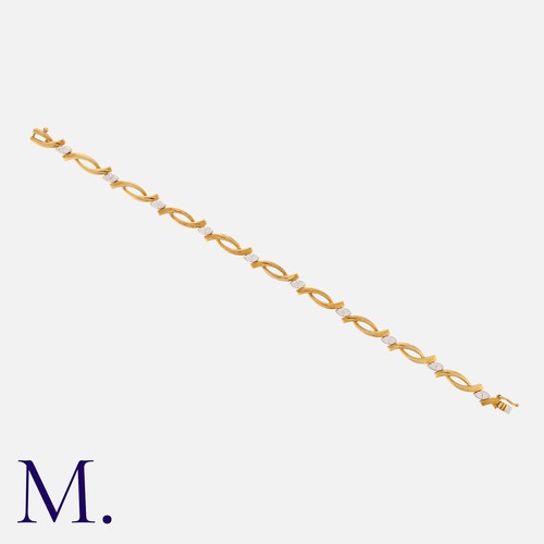 167 - A Gold And Diamond Bracelet in 18k yellow gold, comprising a series of interlocking links, punctuate... 