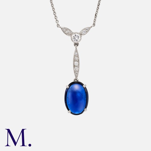 154 - An Unheated Cabochon Sapphire And Diamond Pendant Necklace, in platinum comprising a cabochon blue s... 