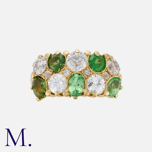 81 - A Green Garnet and Diamond Ring in 18 carat yellow gold, of chequerboard design, set with five princ... 