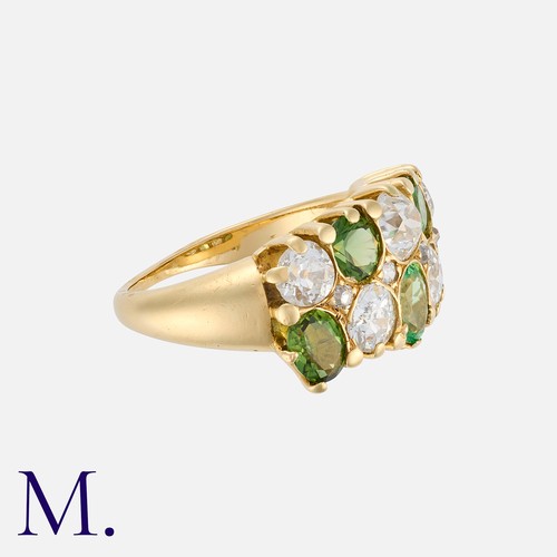 81 - A Green Garnet and Diamond Ring in 18 carat yellow gold, of chequerboard design, set with five princ... 