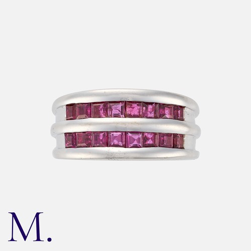 100 - A Ruby Ring in 18 carat white gold, comprising two rows of calibre cut rubies, to a fluted band. Mar... 