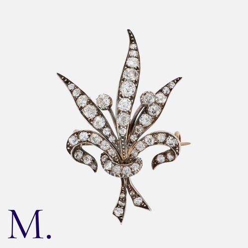 85 - An Antique Diamond Brooch in yellow gold and silver in foliate form, set with old cut diamonds weigh... 