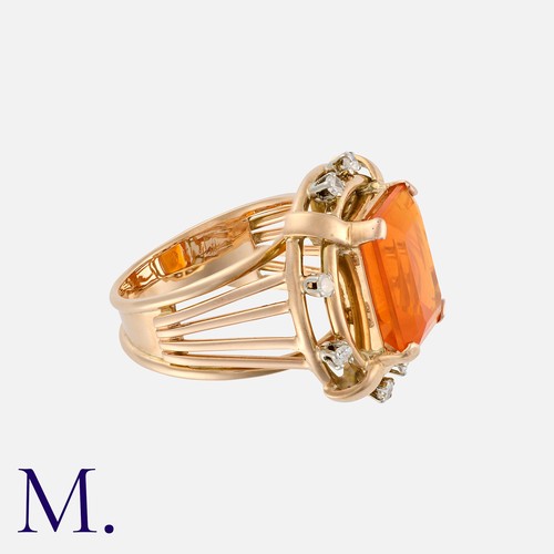 73 - A Fire Opal and Diamond Ring in 18 carat gold, set with an octagonal step cut fire opal of approxima... 