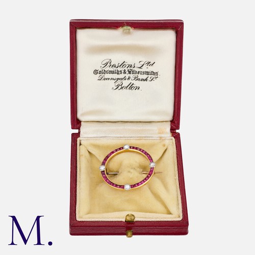 113 - An Art Deco Ruby and Diamond Brooch in yellow gold, of circular form, set with calibre cut rubies, a... 