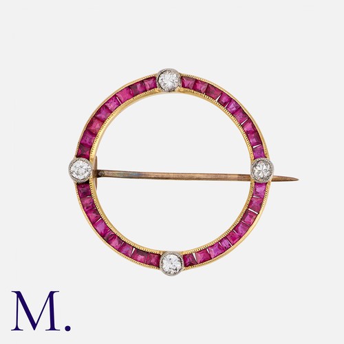 113 - An Art Deco Ruby and Diamond Brooch in yellow gold, of circular form, set with calibre cut rubies, a... 