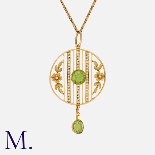 89 - An Edwardian Peridot and Pearl Pendant Necklace in 15 carat yellow gold, of openwork circular form, ... 