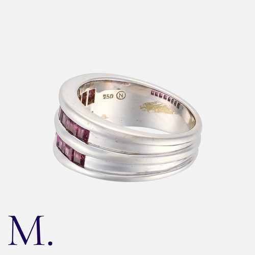 84 - A Ruby Ring in 18 carat white gold, comprising two rows of calibre cut rubies, to a fluted band. Mar... 