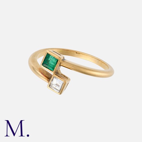 6 - An Emerald and Diamond Toi et Moi Ring in yellow gold, one terminal set with a square cut emerald, t... 