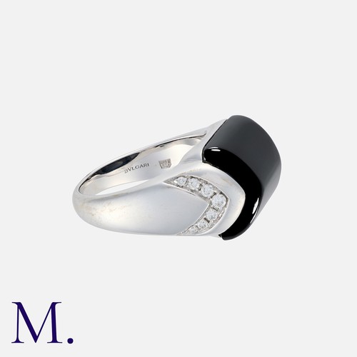 76 - BULGARI. An Onyx and Diamond Tronchetto Ring in 18K white gold set with a principal polished onyx wi... 