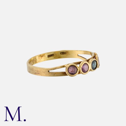 55 - A Ruby and Sapphire Ring in 18 carat yellow gold, set with a central oval cut sapphire, flanked eith... 