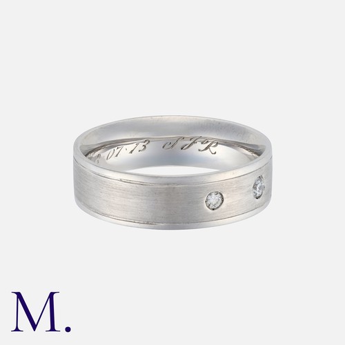59 - A Diamond-Set Band in 18K white gold with matte finish to the outside of the band, set with three ro... 