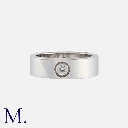 61 - CARTIER. A Diamond Band in 18K white gold with a brilliant cut diamond set to the centre of a folded... 