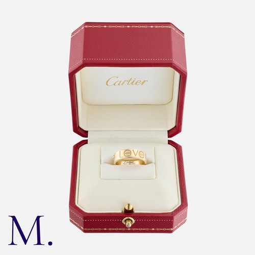 63 - CARTIER. A Love Ring in 18K yellow gold with 'LøVE' engraved to the outside of the band.  Signed Car... 