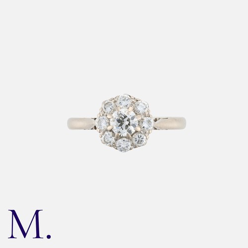 101 - A Diamond Cluster Ring in 18k white gold, comprising a central round cut diamond within a border of ... 