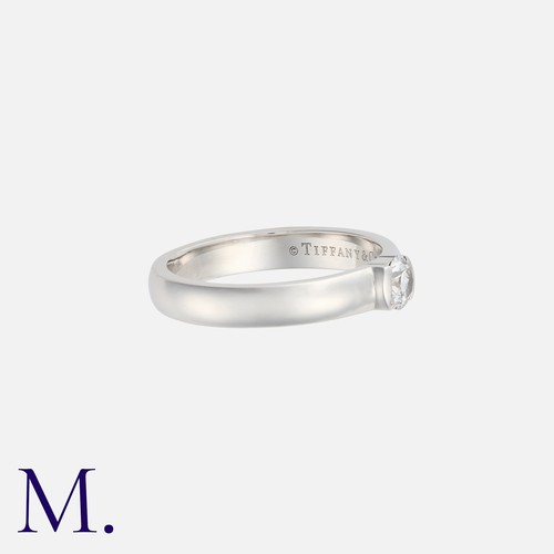 65 - TIFFANY & CO. A Diamond Ring in platinum set with a round brilliant cut diamond weighing 0.29ct.

Si... 