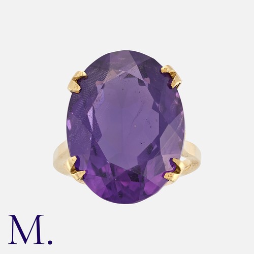 26 - A Large Amethyst Ring in yellow gold, set with an oval cut amethyst weighing approximately 12.5ct.  ... 