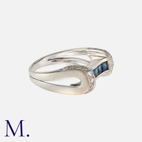 105 - A Sapphire and Diamond Ring in 18K white gold, set with approximately 0.25ct of round cut diamonds w... 
