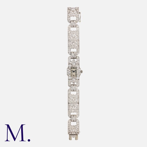 60 - An Art Deco Diamond Cocktail Bracelet Watch in platinum, the silver dial with Arabic numerals and bl... 