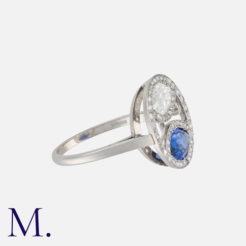 36 - WARTSKI, A Sapphire and Diamond Ring in platinum, comprising a marquise cut sapphire of approximatel... 