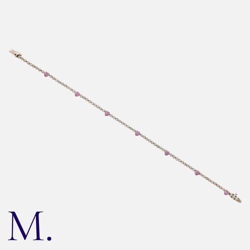 57 - A Diamond and Pink Sapphire Bracelet in 18 carat white gold, comprising a row of round cut diamonds ... 