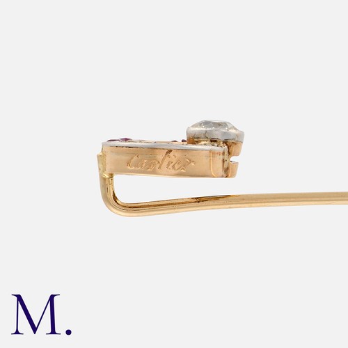 39 - A Ruby and Diamond Stick Pin in yellow gold, the terminal designed as an open circle, set with an ol... 
