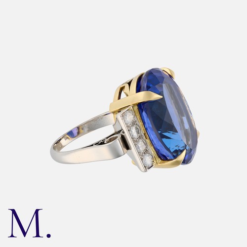 56 - A Fine 24.90 Carat Tanzanite and Diamond Ring in yellow and white gold, set with a large Tanzanite o... 