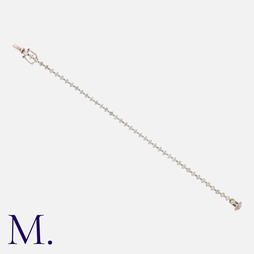 55 - A Diamond Line Bracelet in 18 carat white gold, set with round brilliant cut diamonds totalling appr... 