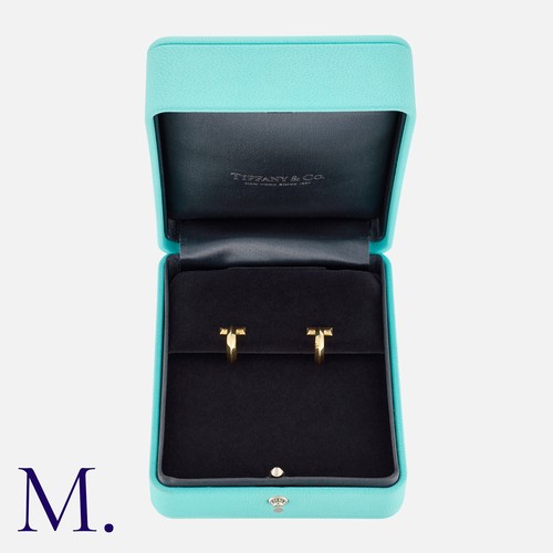 18 - Tiffany & Co. A Pair of 'T:T1' Hoop Earrings in 18 carat yellow gold, each comprising the capital le... 