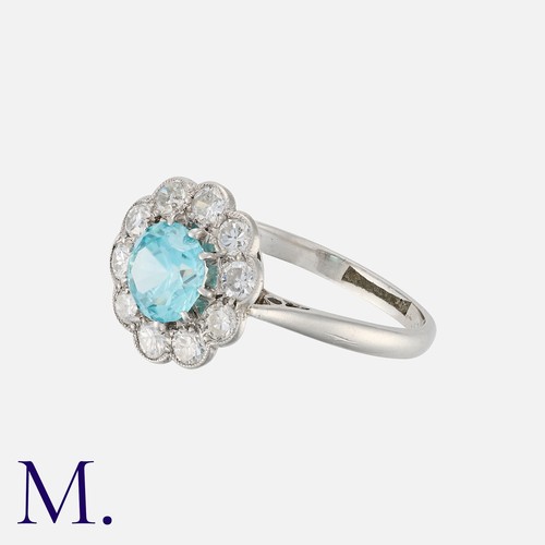 44 - A Zircon and Diamond Cluster Ring in white gold, set with a round cut zircon of approximately 1.20 c... 