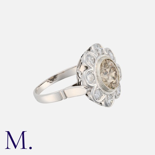 30 - A 2.14 Carat Diamond Cluster Ring in 18 carat white gold and platinum, set with a principal coloured... 