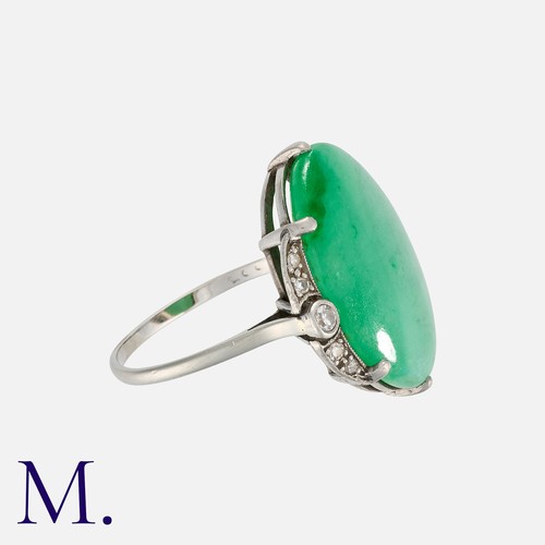 92 - An Art Deco Jade and Diamond Ring in white gold, set with a cabochon of approximately 10.0 carats, a... 